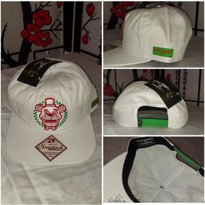 White snapback featuring a red and green stitched patch of Freddy Fazbear